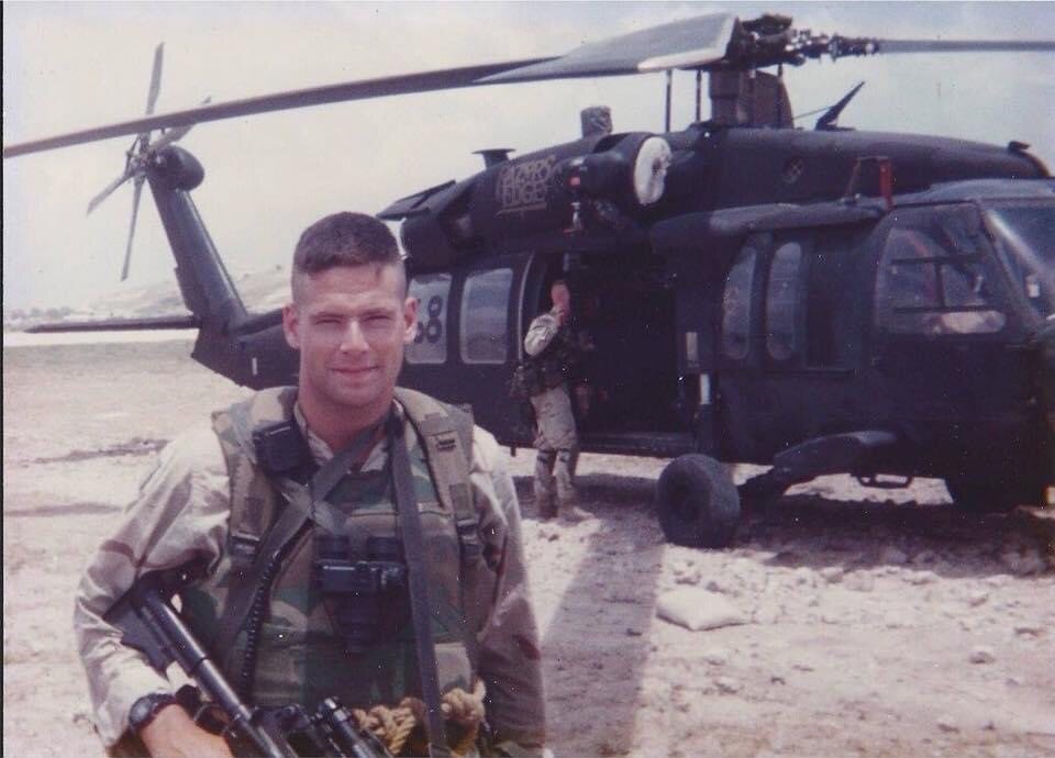 John Belman in Somalia in 1993, standing in front of a Black Hawk helicopter.